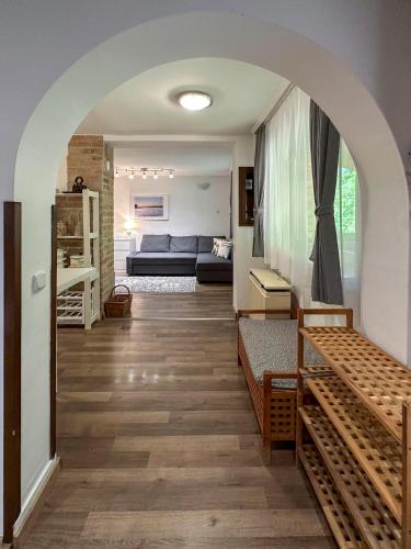 a living room with an archway and a room with a couch at Tommy's Cottage in Harta