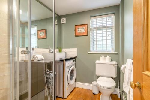 a bathroom with a toilet and a washing machine at 5 Bed in Belper oc-b29775 in Belper