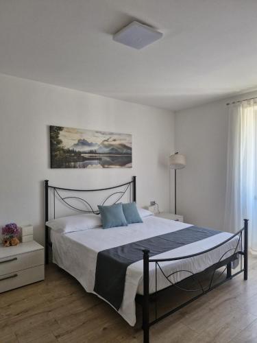 a bedroom with a large bed with blue pillows at La Casa Verde - Apartment in Lasino