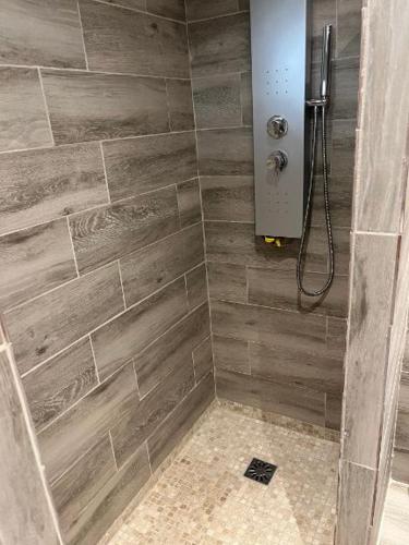 a bathroom with a shower with wooden tiles at Les Cigales in La Crau