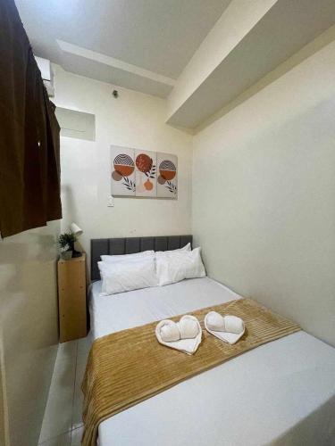 a bedroom with a bed with two hearts on it at Casa Lumière in Tagaytay
