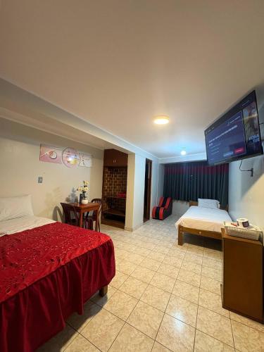 a hotel room with a bed and a flat screen tv at Hospedaje W TAWA in Lima