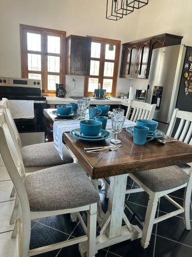 a kitchen with a wooden table with blue bowls on it at Apartment 1 Peniel in Copán Ruinas