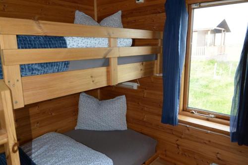 a bunk bed in a cabin with a window at Egilsstaðir 1, Sjónarhóll, Urridafossvegur, Selfoss in Selfoss