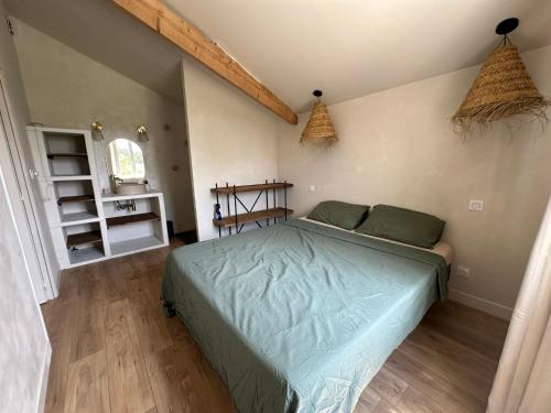 a bedroom with a green bed in a room at La parenthèse in Lagrave