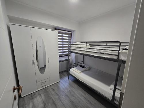 a small room with two bunk beds and a window at Smiljana 36 in Klimno