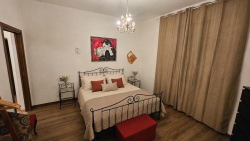 a bedroom with a bed and a chandelier at B&B La Torretta dei Ricordi in Formigine