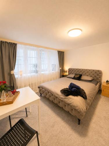 a bedroom with a bed in a room with a table at Old-Town Studios Zürich in Zurich