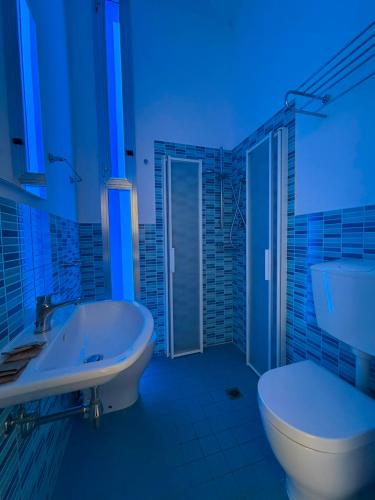 a bathroom with a tub and a toilet and a sink at K2 Hotel in Cattolica