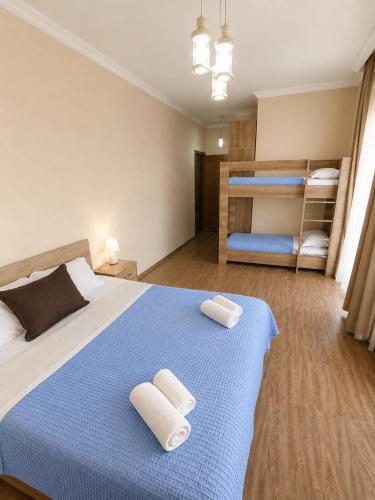 a bedroom with a bed with two towels on it at Sunny Hotel in Kobuleti