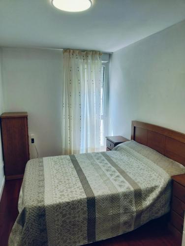 a bedroom with a bed and a window at apartamento victor in Cee