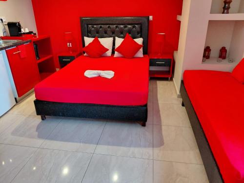 a red bedroom with a red bed with a bow tie at Apartments Vesna Luxury & Michel ap 8 in Paralia Katerinis