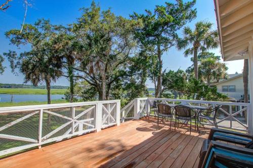 a wooden deck with a table and chairs on it at The Toasted Oyster in Edisto Island