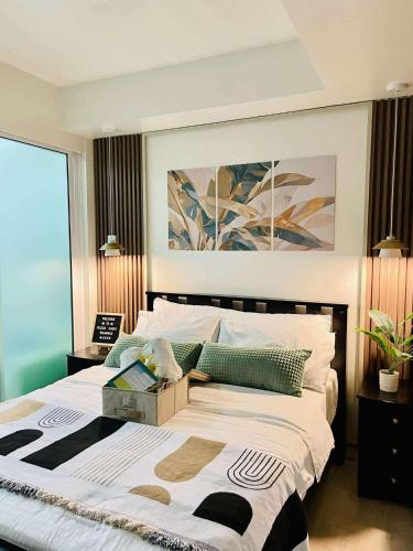 a bedroom with a large bed with a box on it at SM Bicutan Staycation by Urban Suite in Manila