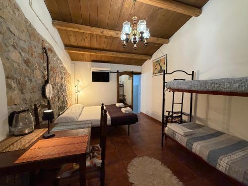 a room with two bunk beds and a table at La Dimora del Grano in Rignano Garganico
