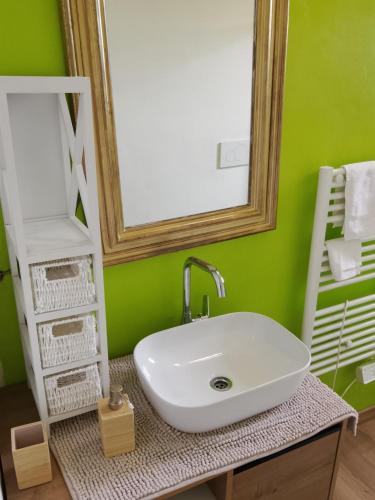 a bathroom with a white sink and a mirror at Borgo antico Pisa in Montecastello