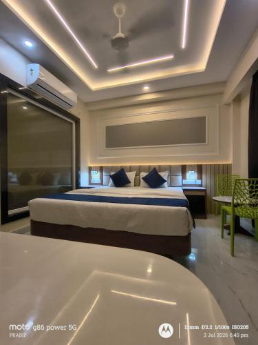 a hotel room with a bed and a bath tub at Asusss International in New Digha
