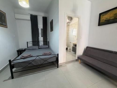 a bedroom with a bed and a couch in it at Piraeus Sea Loft in Piraeus