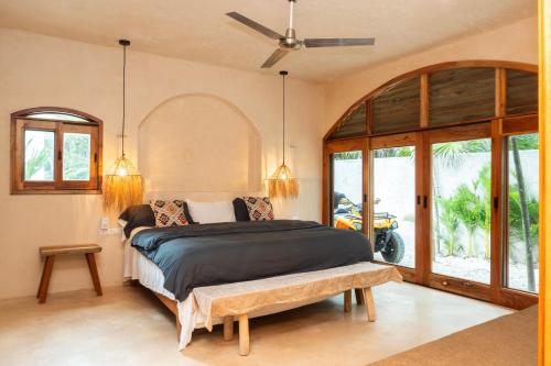 a bedroom with a bed and a large window at Villa Hydra Private Villa with Rooftop Pool in El Cuyo