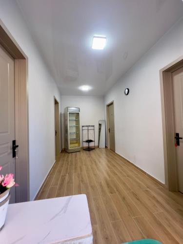 an empty room with white walls and wooden floors at Maya Seaside Ureki in Ureki