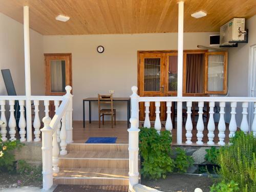 a porch of a house with a white railing at Maya Seaside Ureki in Ureki