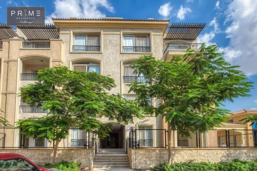 an apartment building with trees in front of it at Prime Residence Kattameya in Cairo