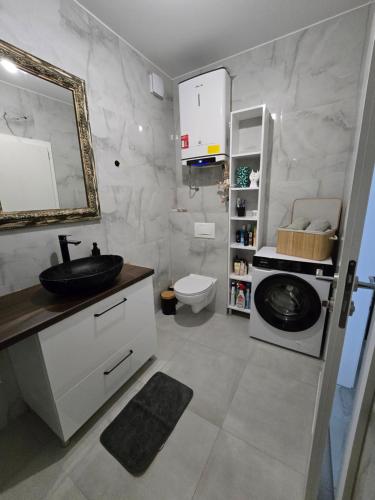 a bathroom with a sink and a toilet at Mare Ann in Ljubuški
