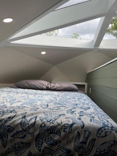 a bedroom with a bed with a large window at Blue Bayou Dome cottages in Dingwall