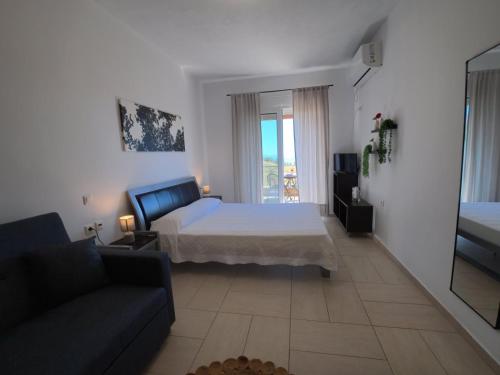 a living room with a bed and a couch at Billys studios in Karistos