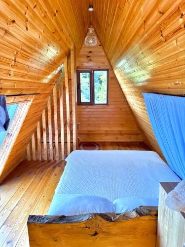 a bedroom with a bed in a wooden cabin at Marco Polo Sarpi in Batumi