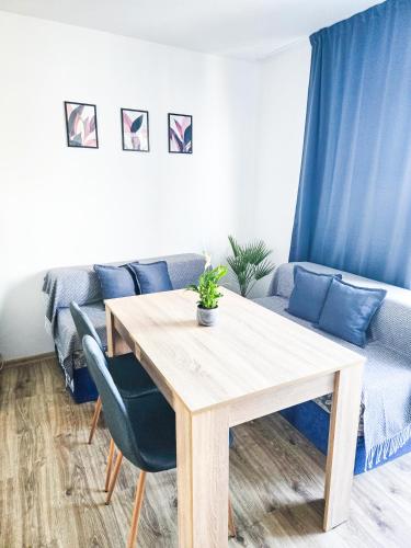a living room with a wooden table and a couch at Guest House Medusa - Old town in Pomorie