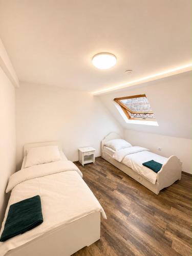 a bedroom with two beds and a skylight at Ferien Wohnung in Traben-Trarbach