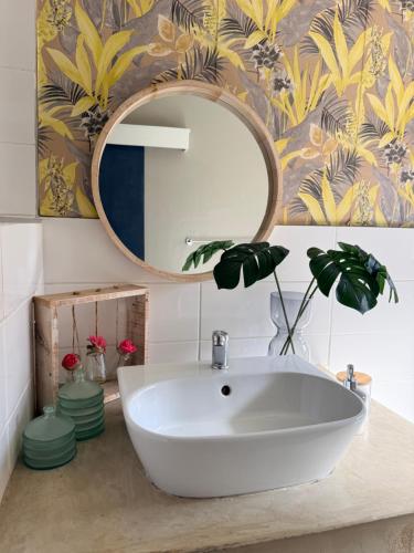 a bathroom with a white sink and a mirror at Lielies Guesthouse in Parys