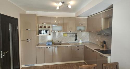 a kitchen with a sink and a counter top at Sun Sea App in Shkorpilovtsi