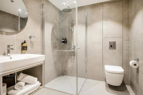 a bathroom with a shower and a toilet and a sink at Filefjellstuene Hotel in Tyinkrysset