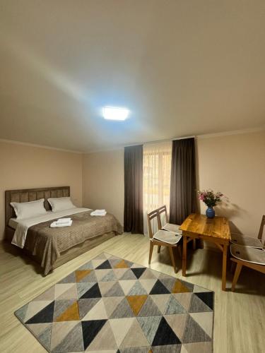 a hotel room with a bed and a table and a table sidx sidx at Studio Apartment Goris in Goris
