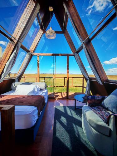 a room with two beds and a window at Titicaca wasy lodge in Puno