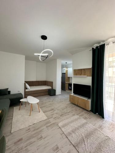 a living room with a couch and a table at A&H Apartment 2 in Shëngjin