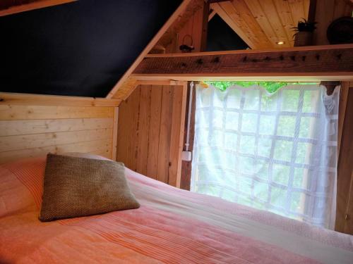 a bedroom with a bed with a large window at Sauna Suite 1 in Valga