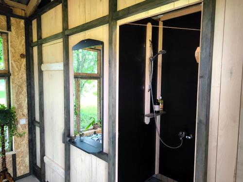 a bathroom with a shower and a window and a sink at Sauna Suite 1 in Valga