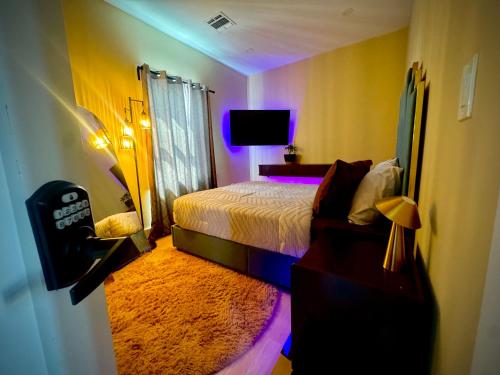 a bedroom with a bed and a purple light at La Suite de Antonio Shared Property PRIVATE stay NYC 18mins in North Bergen