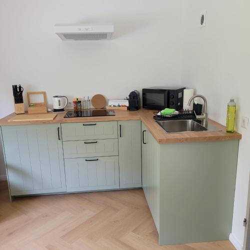 a kitchen with a sink and a microwave at Ferienwohnung mit Bergblick in Oberammergau