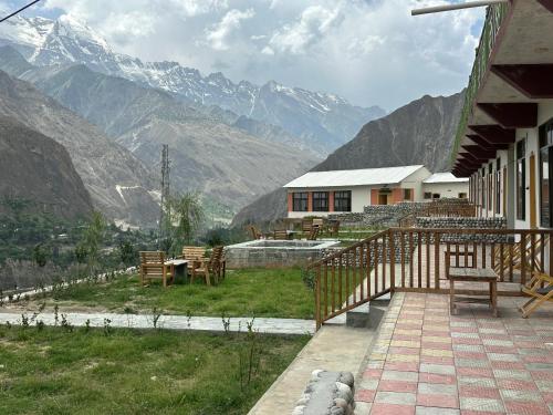 a house with a patio with mountains in the background at KOH E QAF HUNZA in Hini