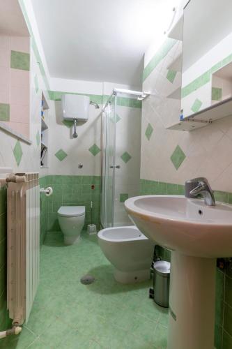 a bathroom with a sink and a toilet and a shower at Pietramarina162 in Camerota