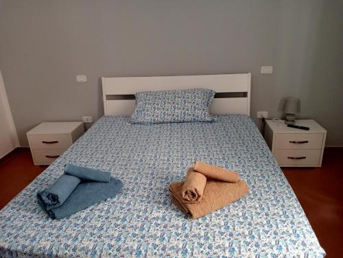a bedroom with a bed with two towels on it at Pietramarina162 in Camerota