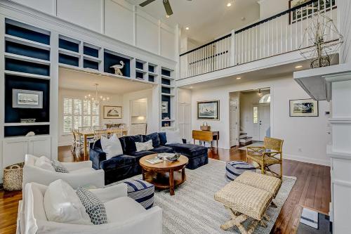 a living room with white furniture and a dining room at Luna Sea in Edisto Beach