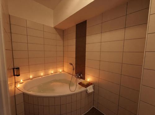 a bathroom with a tub with lights in it at Hotel Markgräfler Hof in Badenweiler