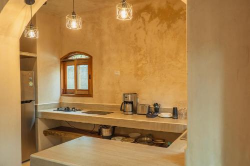 a kitchen with a counter and a sink in a room at Villa Hydra Private Villa with Rooftop Pool in El Cuyo