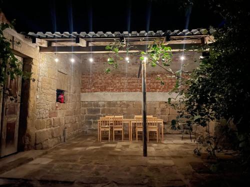 a table and chairs in a patio at night at Chlum 1 in Chlum