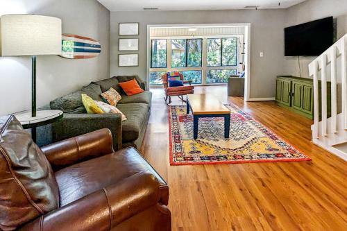 a living room with a couch and a table at The Pirate Den in Edisto Beach